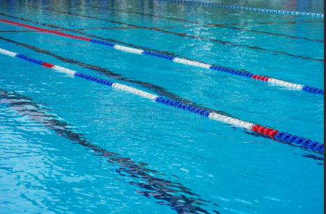an empty swimming pool with lanes set out ready for a swimming gala