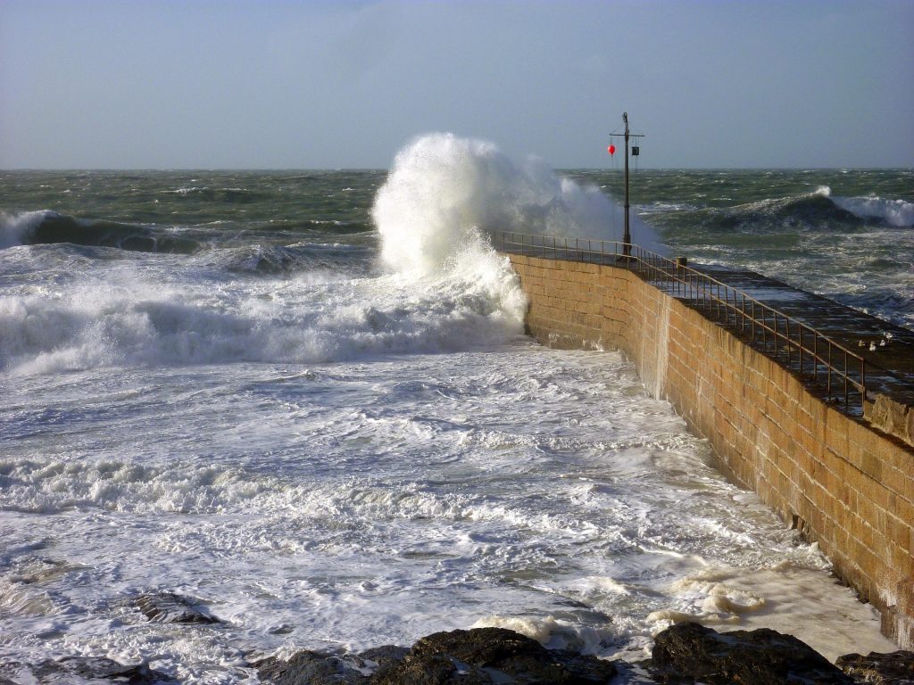 a wave breaking on a breakwater