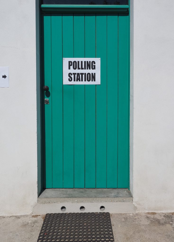 picture of a green door to a polling station